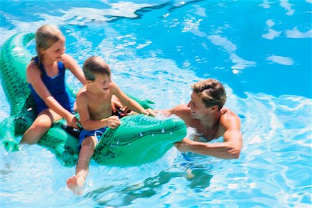 father little girl pool - Father, Son and Daughter on Inflatable Alligator in Water Stock Photo - Rights-Managed, Code: 700-00039573