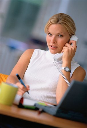 Portrait of Businesswoman Sitting At Desk, Using Phone Foto de stock - Con derechos protegidos, Código: 700-00030020