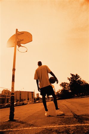 Back View of Male Basketball Player Holding Ball at Outdoor Court Stock Photo - Rights-Managed, Code: 700-00031148