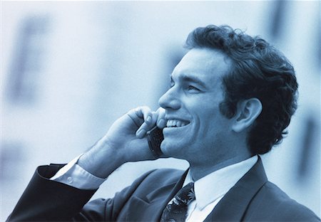 simsearch:700-00027893,k - Businessman Using Cell Phone Smiling Foto de stock - Con derechos protegidos, Código: 700-00031747