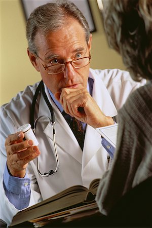 patient talking to office worker - Mature Male Doctor with Patient Stock Photo - Rights-Managed, Code: 700-00032083
