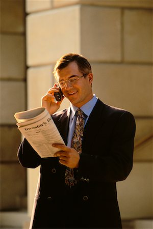 simsearch:700-00043555,k - Businessman Using Cell Phone Reading Newspaper Outdoors Stock Photo - Rights-Managed, Code: 700-00032384