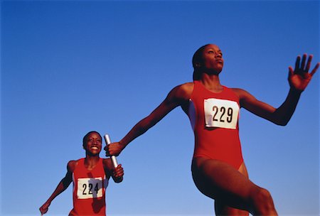 relay race competitions - Female Runners Passing Baton Foto de stock - Con derechos protegidos, Código: 700-00032755