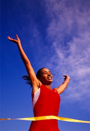 Female Runner Crossing Finish Line Stock Photo - Rights-Managed, Code: 700-00032764