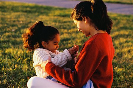 simsearch:700-00059733,k - Daughter Sitting in Mother's Lap Outdoors Foto de stock - Con derechos protegidos, Código: 700-00032811