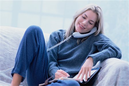 Woman Sitting on Sofa, Using Phone Stock Photo - Rights-Managed, Code: 700-00032854