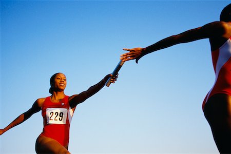 relay race competitions - Female Runners Passing Baton Foto de stock - Con derechos protegidos, Código: 700-00032952