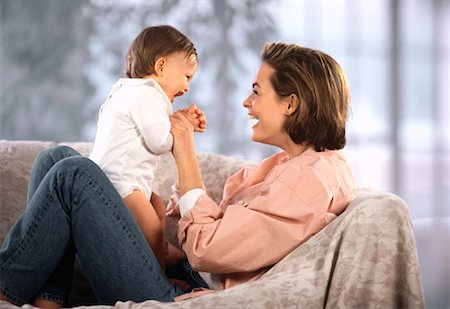 simsearch:700-00865706,k - Mother Holding Baby on Sofa Stock Photo - Rights-Managed, Code: 700-00033005