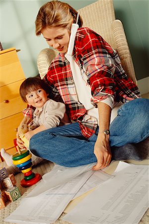 Mother Working Using Cordless Telephone While Toddler Plays Stock Photo - Rights-Managed, Code: 700-00033187