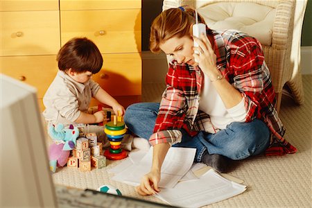 Mother Using Cordless Telephone While Toddler Plays Stock Photo - Rights-Managed, Code: 700-00033188