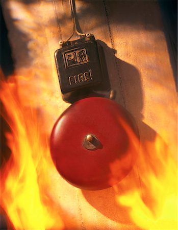 Close-Up of Fire Alarm Ringing Surrounded by Flames Foto de stock - Con derechos protegidos, Código: 700-00044562