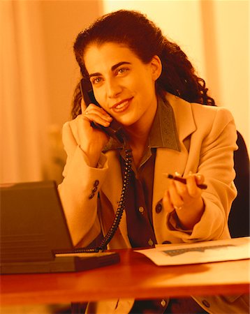 pierre tremblay - Businesswoman Using Telephone and Laptop Computer Foto de stock - Con derechos protegidos, Código: 700-00044702