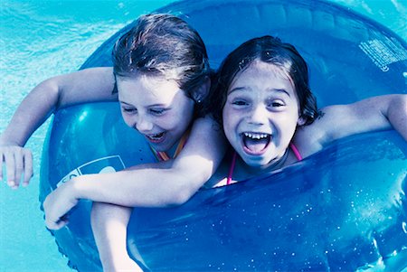 Girls with Inner Tube in Swimming Pool Stock Photo - Rights-Managed, Code: 700-00045020