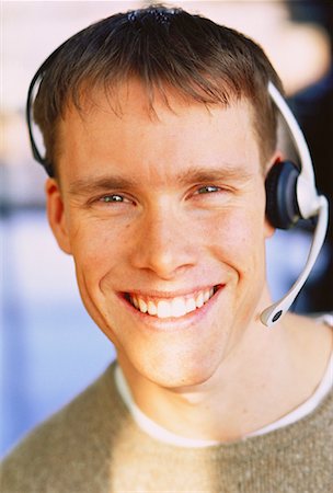 Portrait of Man Wearing Telephone Headset, Smiling Stock Photo - Rights-Managed, Code: 700-00045108