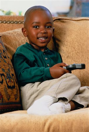 Portrait of Boy on Sofa, Holding Remote Control Stock Photo - Rights-Managed, Code: 700-00045192