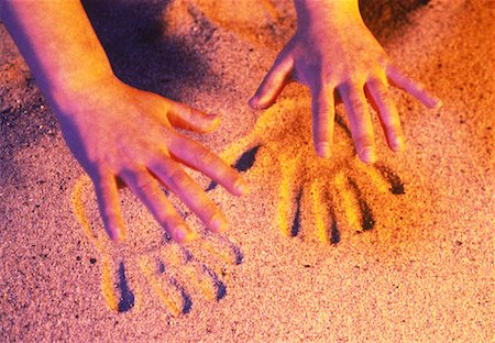 Close-Up of Hands and Handprints In Sand Stock Photo - Rights-Managed, Code: 700-00045321