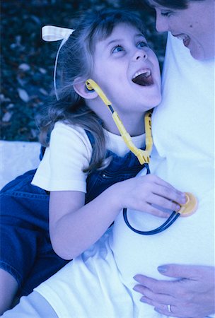 Daughter Using Stethoscope on Expecting Mother's Stomach Stock Photo - Rights-Managed, Code: 700-00045452