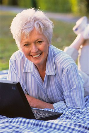 simsearch:700-00053035,k - Portrait of Mature Woman Lying In Field with Laptop Computer Stock Photo - Rights-Managed, Code: 700-00046529