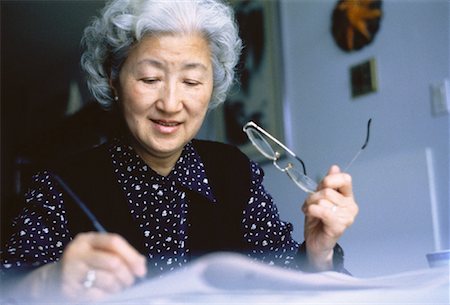 simsearch:700-00023973,k - Mature Woman Doing Crossword Puzzle, Holding Eyeglasses Stock Photo - Rights-Managed, Code: 700-00046806