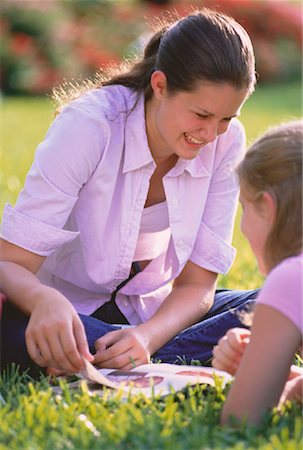 Teenage Girls Sitting on Grass Reading Stock Photo - Rights-Managed, Code: 700-00046835