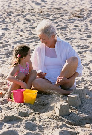 seniors photography girls playing sports - Grandmother and Granddaughter Building Sand Castles on Beach Stock Photo - Rights-Managed, Code: 700-00046924