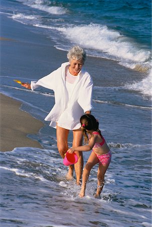 seniors photography girls playing sports - Grandmother and Granddaughter Running in Surf on Beach Stock Photo - Rights-Managed, Code: 700-00046927