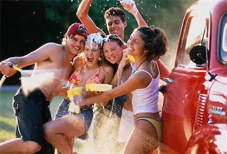Group of Teenagers in Water Fight While Washing Truck Stock Photo - Rights-Managed, Code: 700-00047020