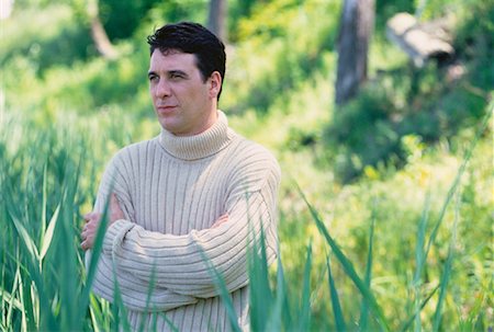 Portrait of Man Standing in Tall Grass Stock Photo - Rights-Managed, Code: 700-00047148