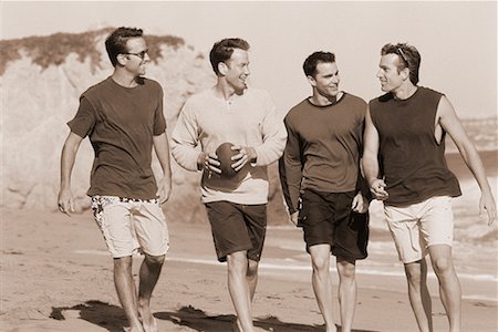 Group of Men Walking on Beach With Football Stock Photo - Rights-Managed, Code: 700-00047243