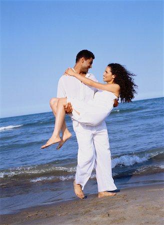 simsearch:600-03456256,k - Man Carrying Woman on Beach Stock Photo - Rights-Managed, Code: 700-00047339