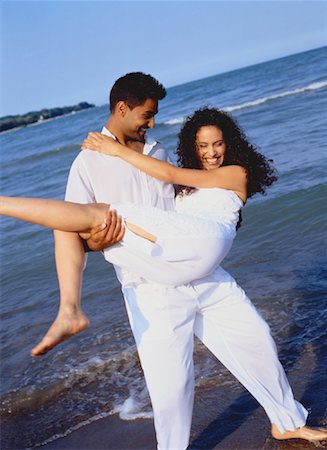 simsearch:600-03456256,k - Man Carrying Woman on Beach Stock Photo - Rights-Managed, Code: 700-00047340