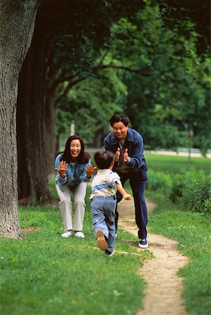 running in city park - Boy Running to Parents Outdoors Stock Photo - Rights-Managed, Code: 700-00047479