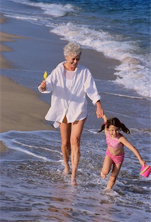 families running in surf on beach - Grandmother and Granddaughter Running in Surf on Beach Stock Photo - Rights-Managed, Code: 700-00047567