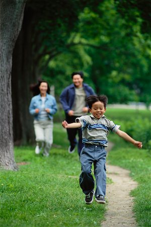 Family Running through Park Stock Photo - Rights-Managed, Code: 700-00047926