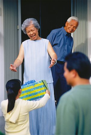 Granddaughter Giving Gift to Grandmother Stock Photo - Rights-Managed, Code: 700-00048145