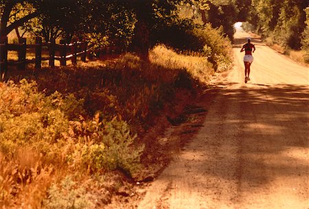 Back View of Woman Running Along Road, Boulder, Colorado, USA Stock Photo - Rights-Managed, Code: 700-00048191