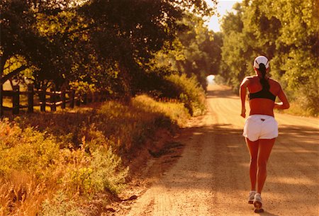 Back View of Woman Running Along Road, Boulder, Colorado, USA Stock Photo - Rights-Managed, Code: 700-00048193