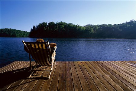 Back View of Man Sitting in Beach Chair on Dock Meech Lake, Quebec, Canada Stock Photo - Rights-Managed, Code: 700-00049416