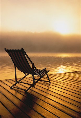 pictures chair dock sunset - Beach Chair on Dock at Sunrise Meech Lake, Quebec, Canada Stock Photo - Rights-Managed, Code: 700-00049417