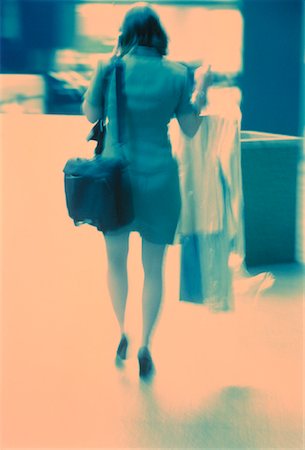 dry-cleaning - Back View of Businesswoman with Cell Phone and Dry Cleaning Stock Photo - Rights-Managed, Code: 700-00049451