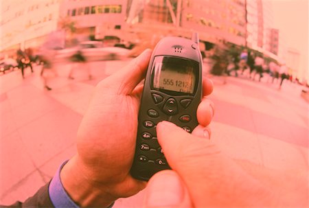 simsearch:700-00284729,k - Close-Up of Hands Holding Cell Phone on Street Foto de stock - Con derechos protegidos, Código: 700-00049477