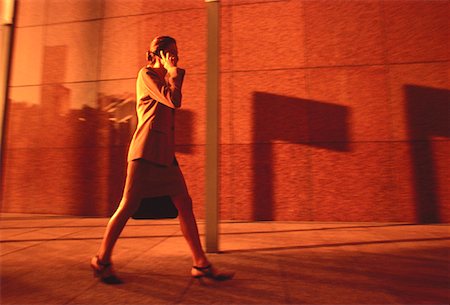 simsearch:700-00064433,k - Businesswoman Walking on Street Using Cell Phone Stock Photo - Rights-Managed, Code: 700-00049657