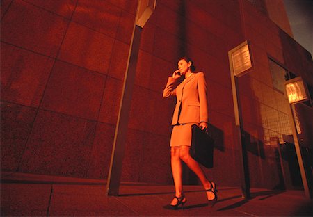 simsearch:700-00064433,k - Businesswoman Walking on Street Using Cell Phone Stock Photo - Rights-Managed, Code: 700-00049658