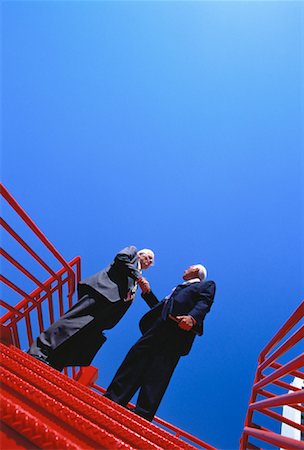 Mature Businessmen Shaking Hands On Stairs Outdoors Foto de stock - Con derechos protegidos, Código: 700-00049882