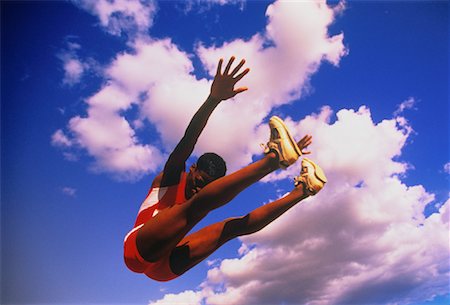 salto em distância - Woman Long Jumping Foto de stock - Direito Controlado, Número: 700-00041085