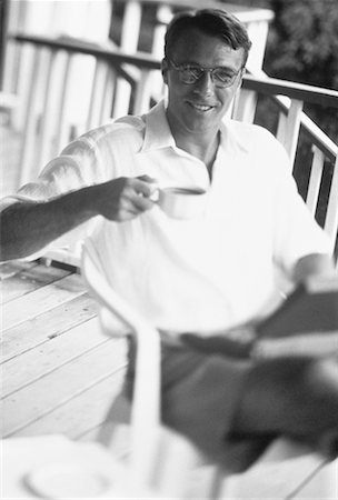 Portrait of Man in Chair on Porch with Laptop and Cup Bahamas Stock Photo - Rights-Managed, Code: 700-00041376