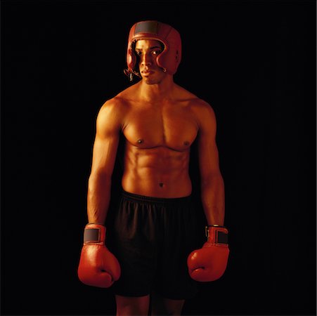 Portrait of Male Boxer Wearing Helmet and Boxing Gloves Stock Photo - Rights-Managed, Code: 700-00041996