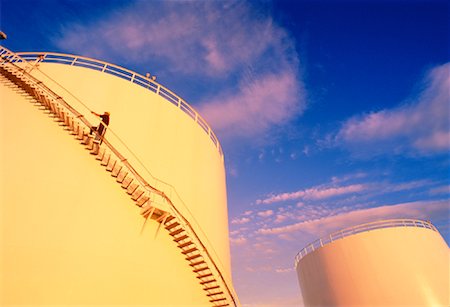 Man Walking Up Stairs on Oil Storage Tank Calgary, Alberta, Canada Stock Photo - Rights-Managed, Code: 700-00042135