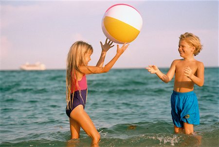 Boy and Girl in Swimwear, Playing With Beach Ball on Beach Stock Photo - Rights-Managed, Code: 700-00042269