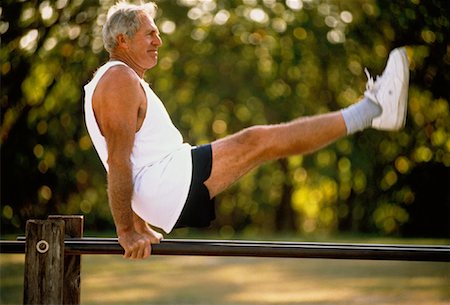 Mature Man on Parallel Bars Outdoors Stock Photo - Rights-Managed, Code: 700-00042569